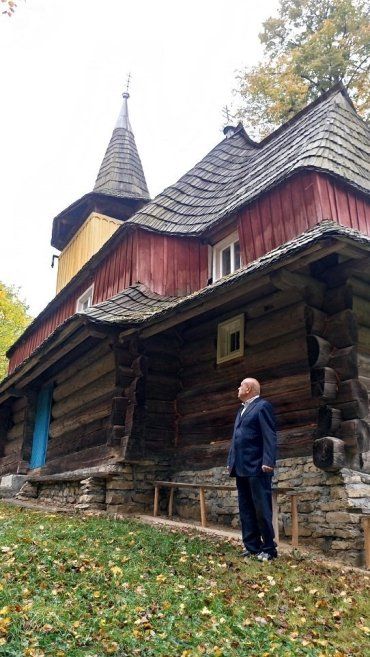 Геннадій Москаль біля дерев’яної церкви на Міжгірщині.
