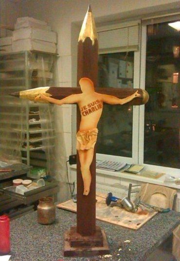 Шоколадный крест в форме журналистских карандашей и образ Христа
